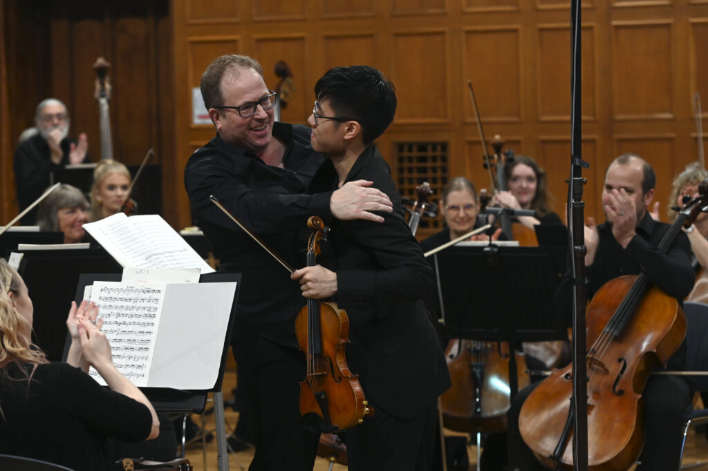 James Li embracing conductor Glyn Oxley.